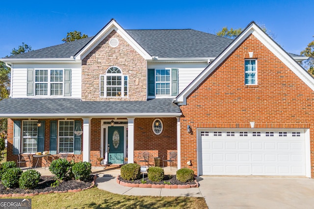 view of front property featuring a porch and a garage