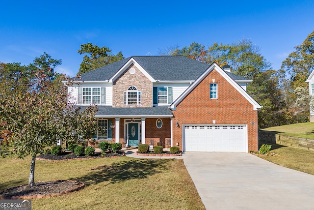 front facade with a front yard, a garage, and covered porch