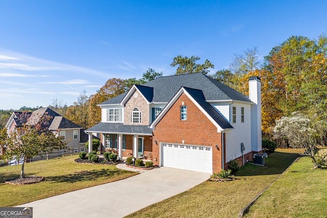 view of front property featuring central air condition unit, a porch, a front yard, and a garage