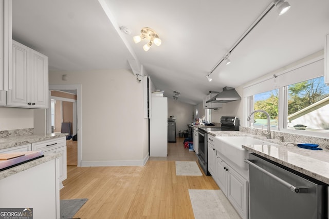 kitchen featuring stainless steel appliances, white cabinetry, wall chimney exhaust hood, and sink