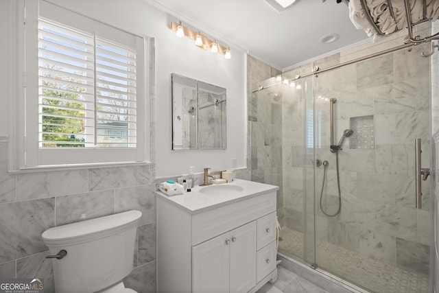 bathroom with vanity, toilet, walk in shower, and tile walls