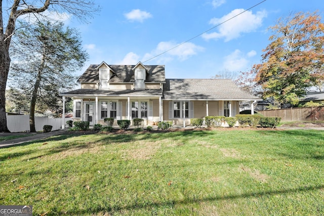 cape cod house with a porch and a front yard