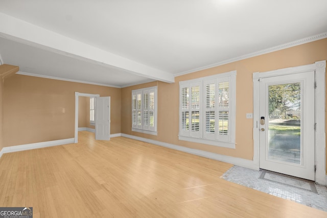 entryway with beamed ceiling, ornamental molding, and light hardwood / wood-style flooring