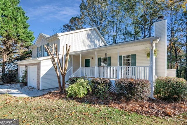 view of front property with covered porch and a garage