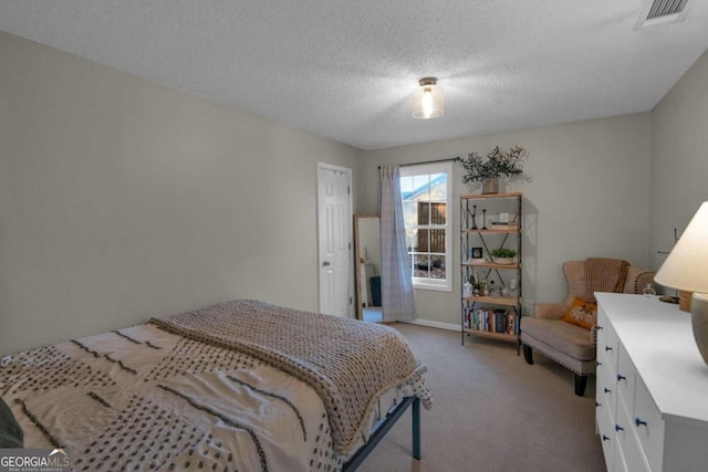 carpeted bedroom featuring a textured ceiling