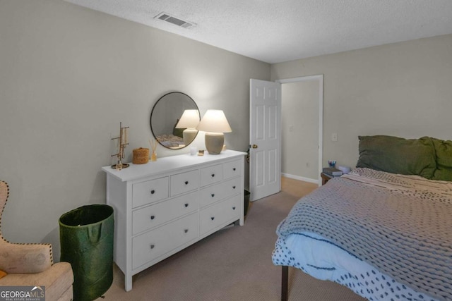 carpeted bedroom featuring a textured ceiling