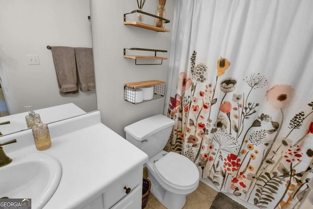 bathroom with tile patterned floors, vanity, and toilet