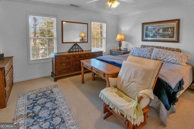 bedroom featuring ceiling fan, crown molding, and light carpet