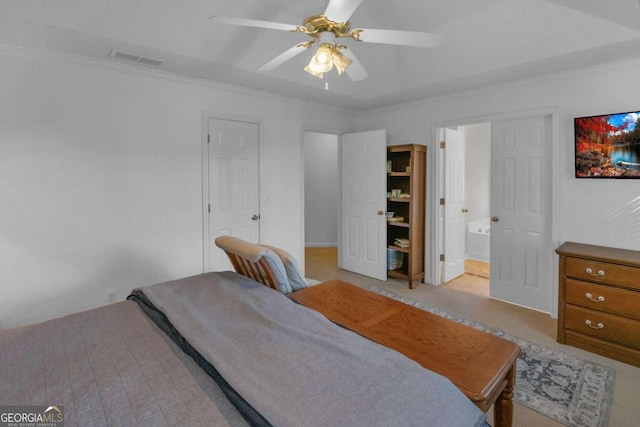 bedroom featuring ceiling fan, crown molding, and ensuite bathroom