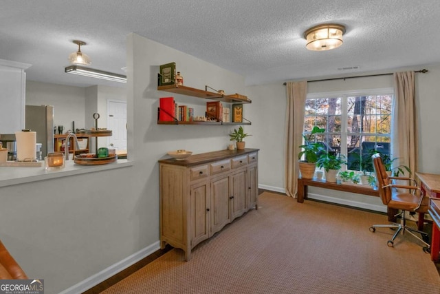 living area featuring light carpet and a textured ceiling