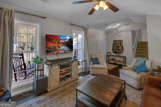 living room featuring hardwood / wood-style floors, ceiling fan, and vaulted ceiling