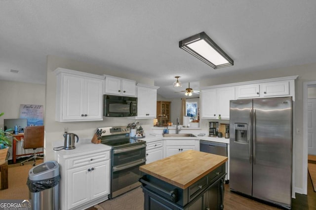 kitchen featuring white cabinets, sink, a kitchen island, and stainless steel appliances