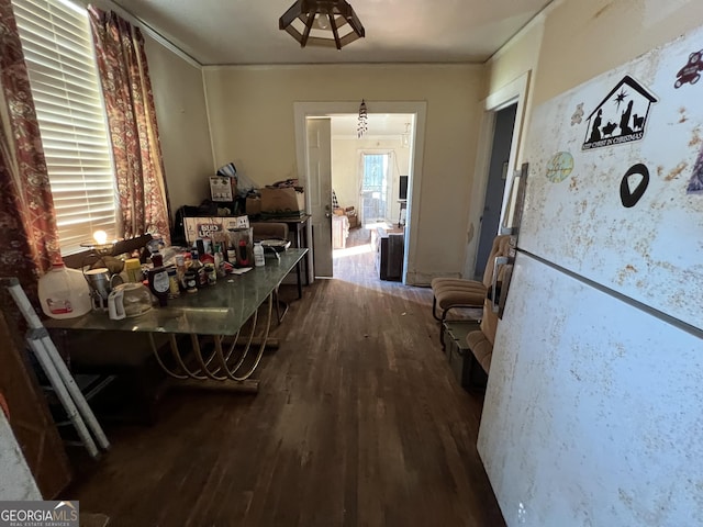 dining area featuring crown molding and wood finished floors