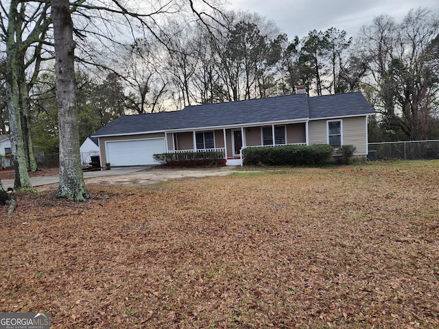 ranch-style house featuring fence, driveway, an attached garage, covered porch, and a chimney