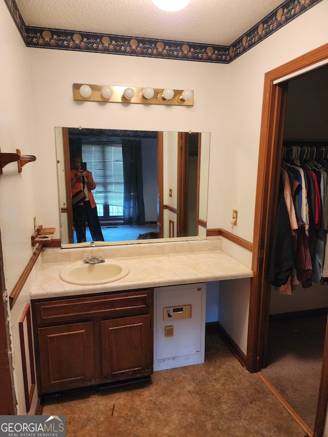 bathroom with vanity and a textured ceiling