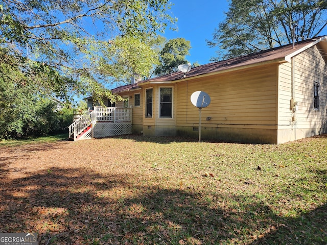 view of property exterior featuring a wooden deck