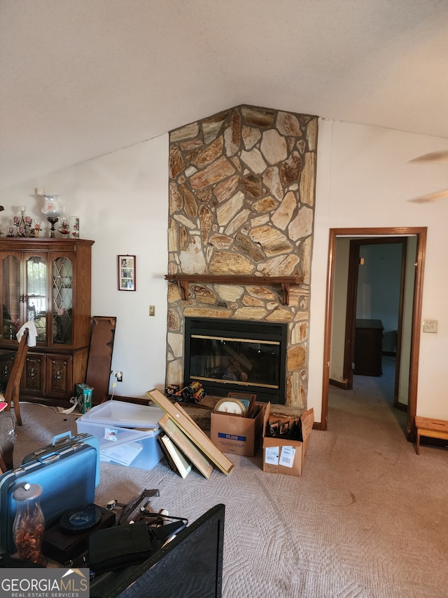 living room featuring carpet, a fireplace, and vaulted ceiling