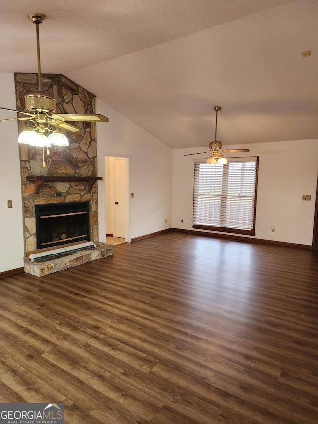 unfurnished living room featuring a fireplace, vaulted ceiling, wood finished floors, and a ceiling fan