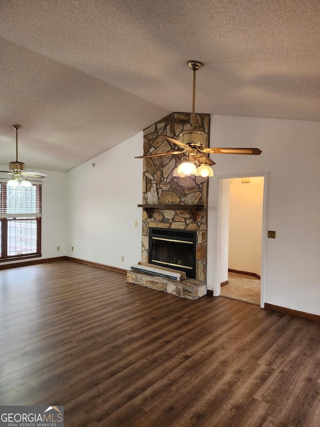 unfurnished living room featuring wood finished floors, a fireplace, a ceiling fan, and vaulted ceiling