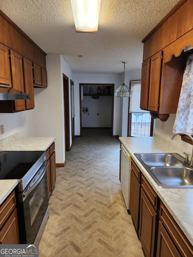 kitchen featuring light countertops, electric range oven, brick floor, white dishwasher, and a sink