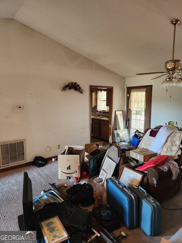 living room featuring ceiling fan, sink, lofted ceiling, and carpet floors