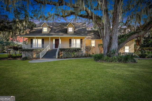 cape cod house with covered porch and a front lawn