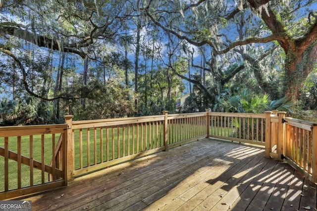 wooden terrace with a lawn