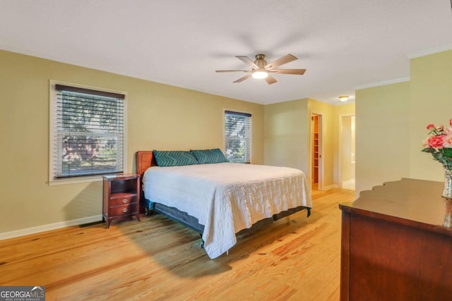 bedroom featuring hardwood / wood-style floors, ceiling fan, and ornamental molding