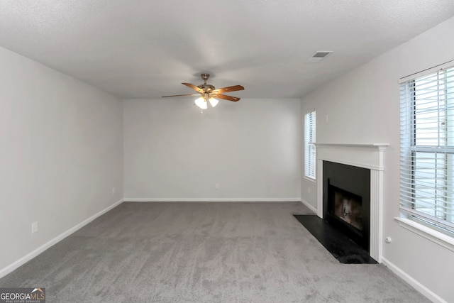 unfurnished living room featuring a textured ceiling, light colored carpet, and ceiling fan