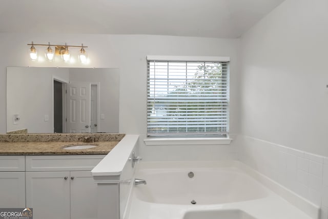 bathroom featuring vanity and a tub to relax in