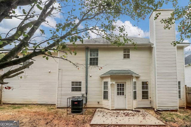 rear view of house featuring central AC unit and a patio area