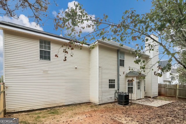 rear view of house featuring central AC unit