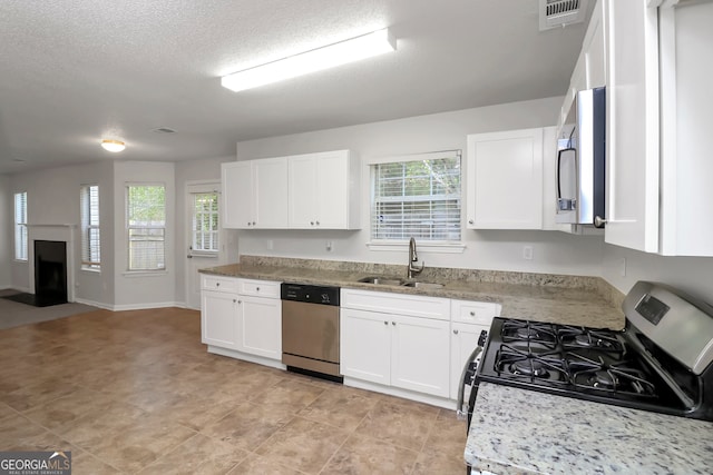 kitchen with sink, white cabinetry, and stainless steel appliances