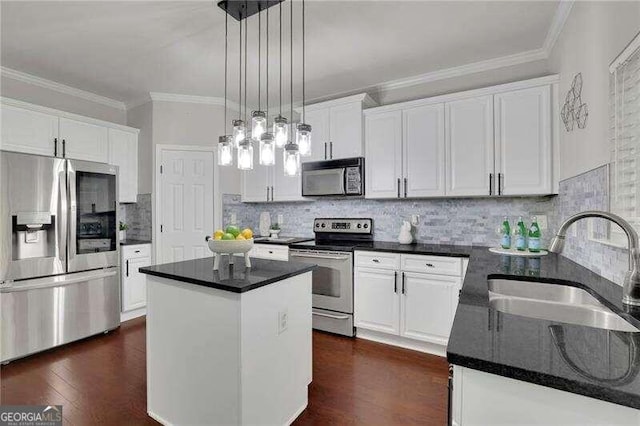 kitchen with white cabinets, sink, a kitchen island, and stainless steel appliances