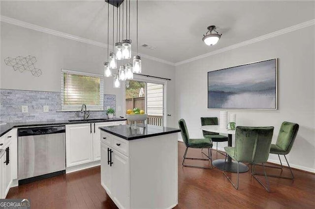 kitchen with pendant lighting, white cabinets, sink, stainless steel dishwasher, and dark hardwood / wood-style flooring