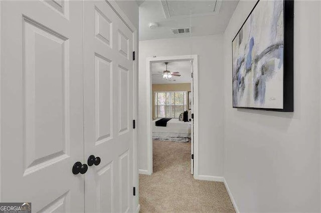 corridor with light colored carpet