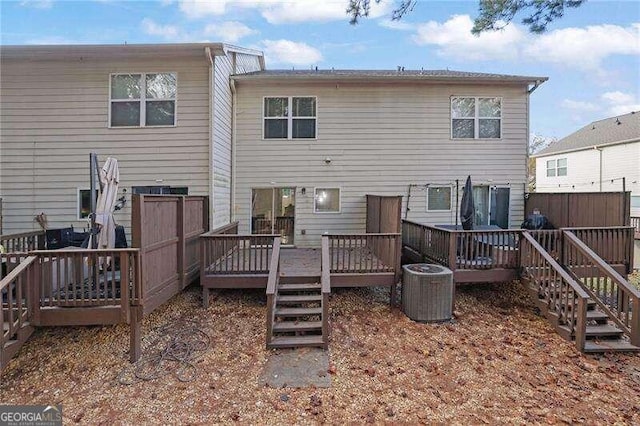 back of house featuring central AC and a deck