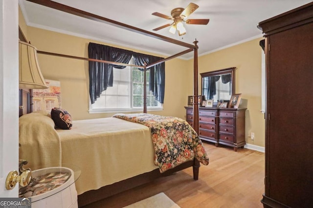 bedroom with ceiling fan, wood-type flooring, and ornamental molding