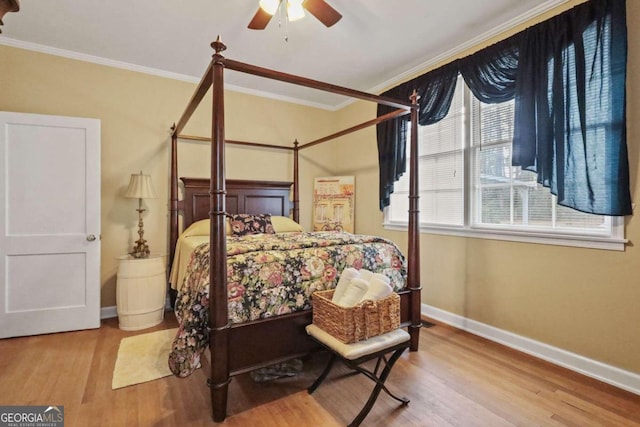 bedroom with ceiling fan, light hardwood / wood-style floors, and ornamental molding