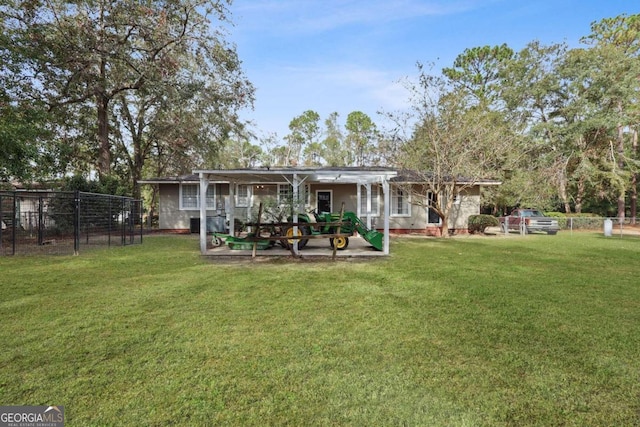 rear view of property with a yard