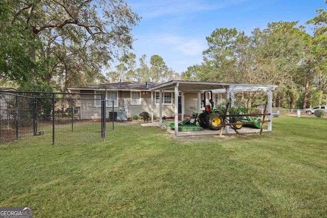 back of house with central AC and a yard