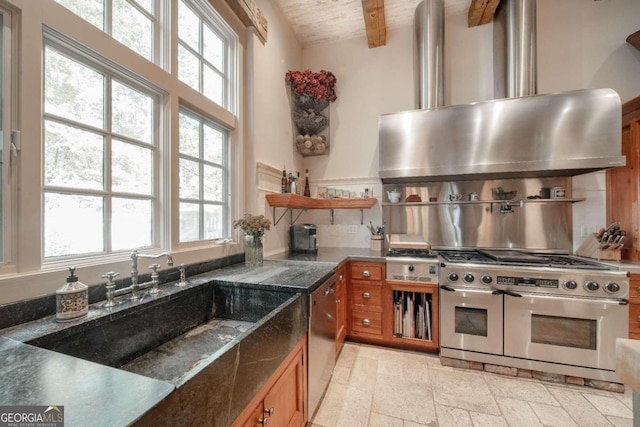 kitchen featuring a wealth of natural light, beamed ceiling, wood ceiling, and appliances with stainless steel finishes