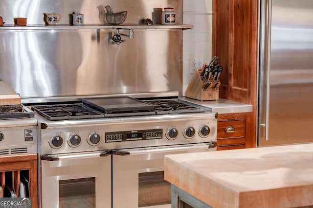 kitchen featuring decorative backsplash and appliances with stainless steel finishes