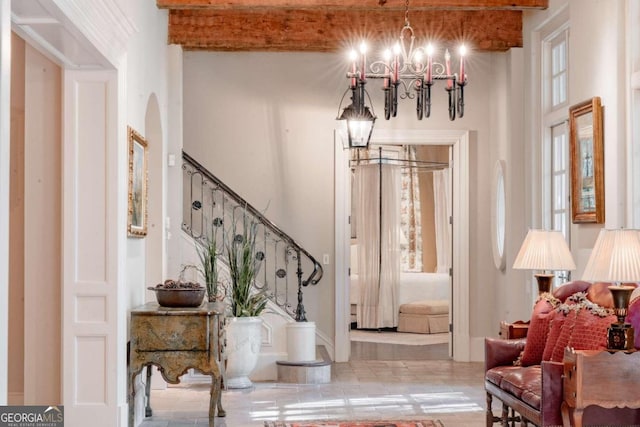 foyer entrance featuring a towering ceiling and an inviting chandelier