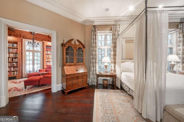 interior space featuring ornamental molding, dark hardwood / wood-style floors, a healthy amount of sunlight, and a notable chandelier