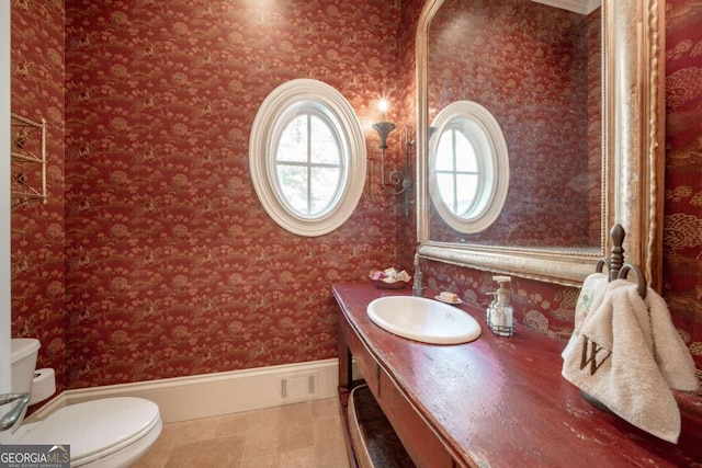 bathroom featuring tile patterned flooring, vanity, and toilet