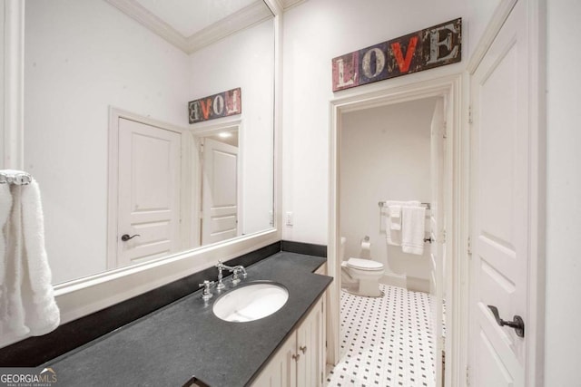 bathroom with vanity, toilet, and ornamental molding