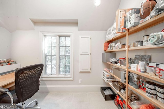 carpeted office space featuring vaulted ceiling