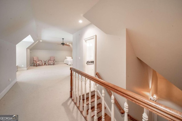 interior space with carpet flooring, ceiling fan, and vaulted ceiling