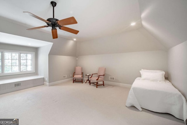 living area with ceiling fan, light colored carpet, and vaulted ceiling